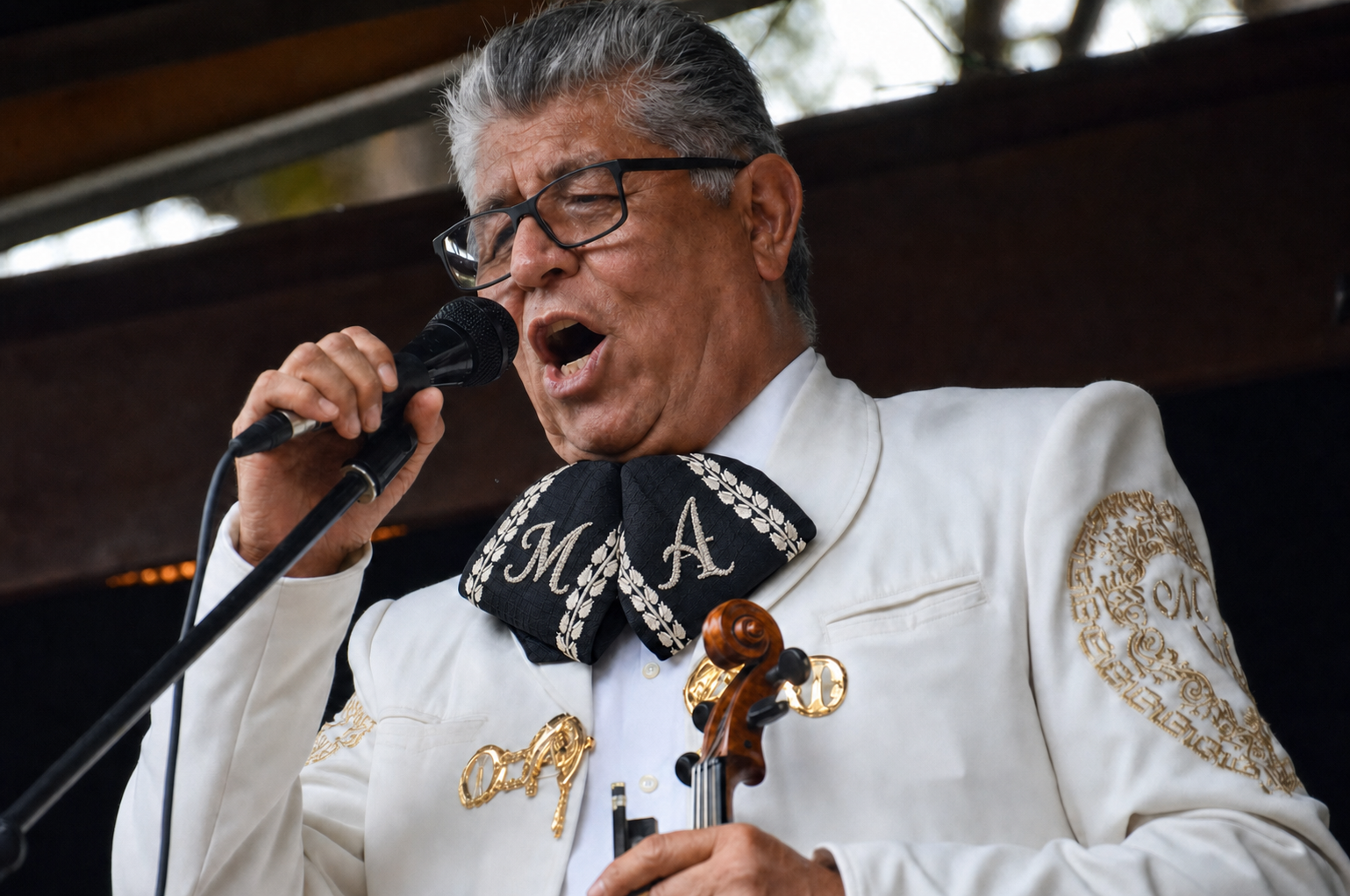 Jaime Cervantes singing in a white charro suit